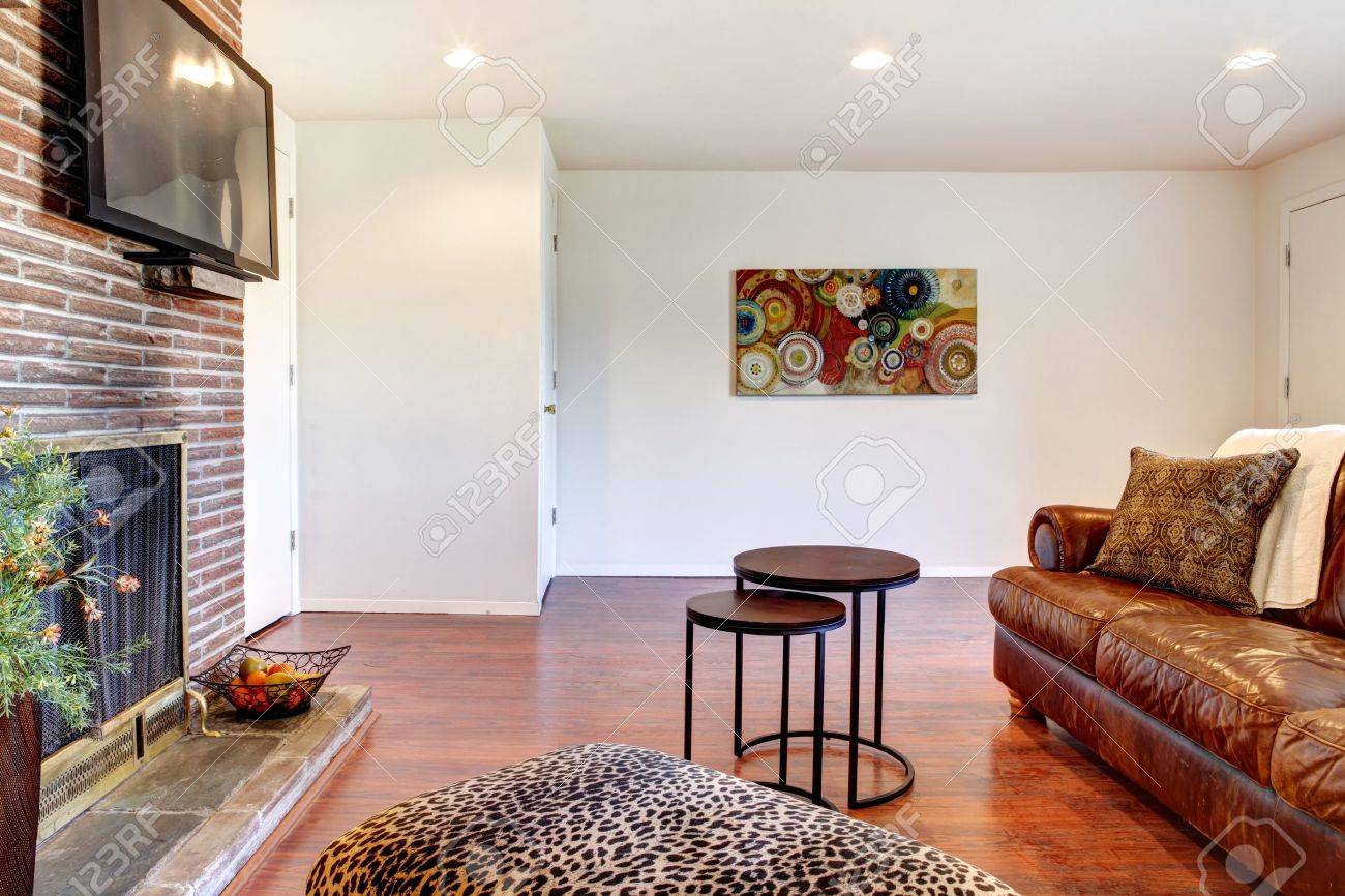 Living room with leather sofa, tv and fireplace. royalty free ...