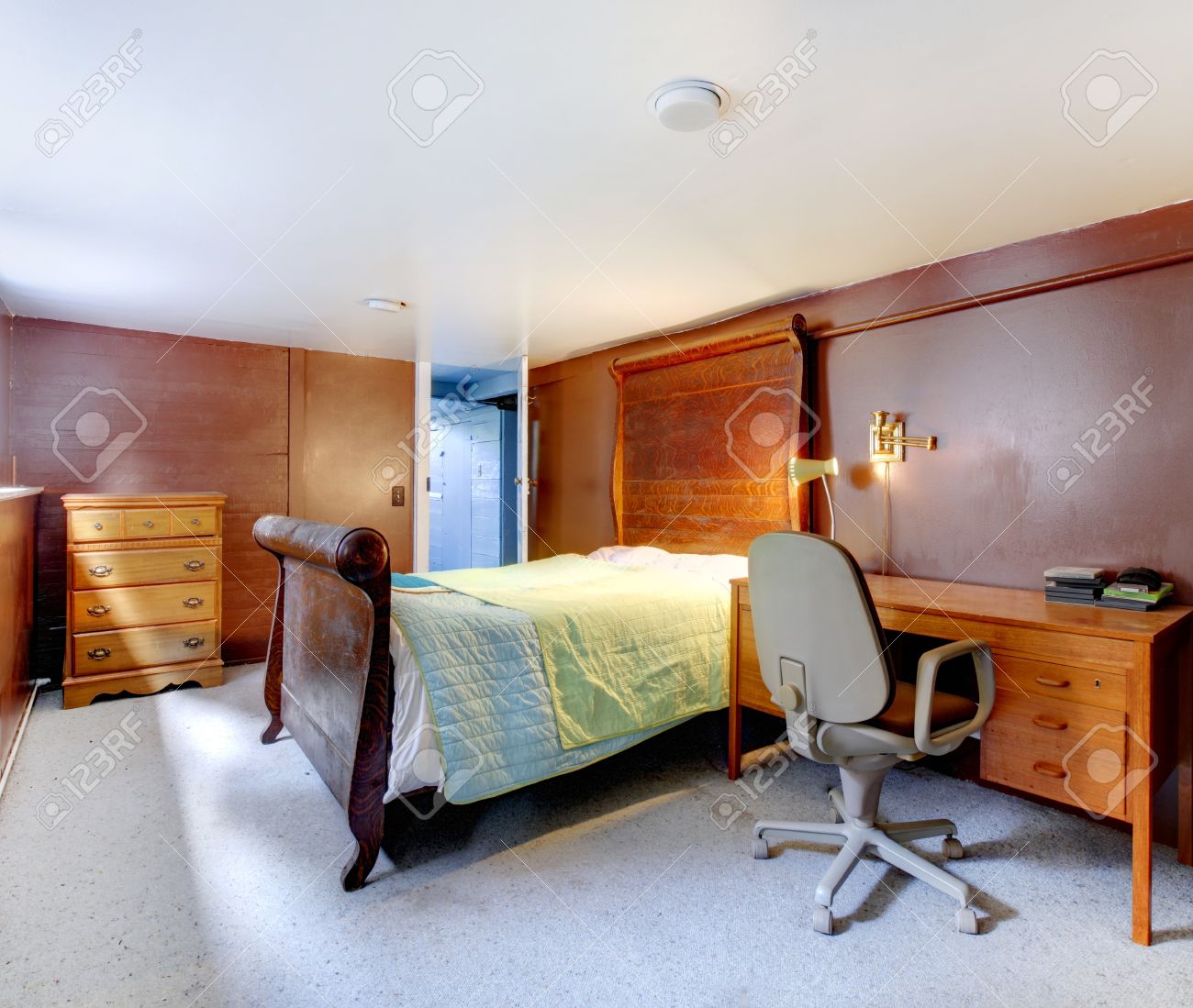 brown bedroom with grey carpet and large bed with green bedding brown bedroom with grey carpet and large bed with green bedding