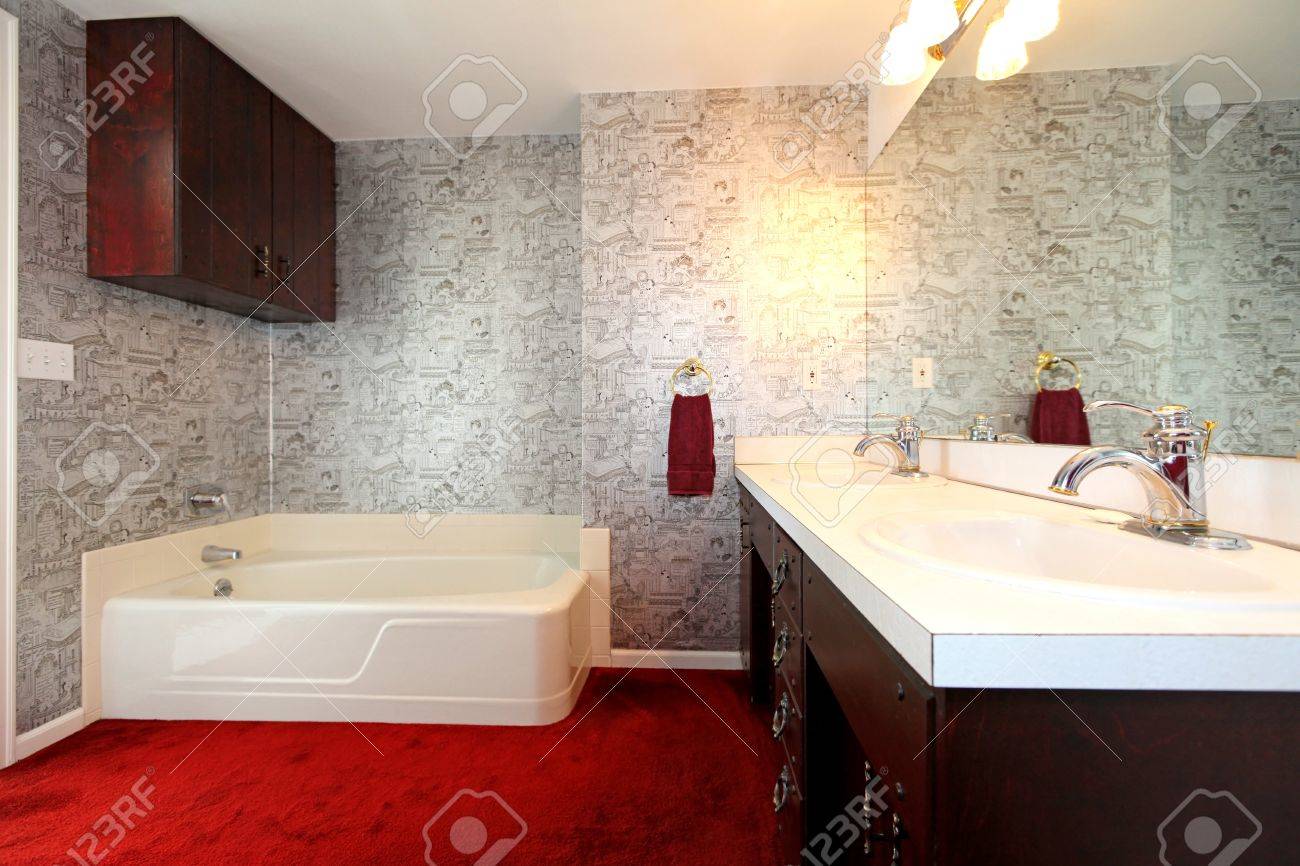old antique bathroom with red carpet, dark wood and wallpaper old antique bathroom with red carpet, dark wood and wallpaper