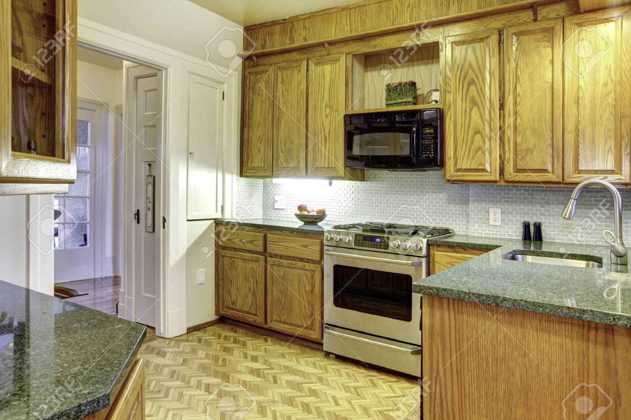 Classic Small Kitchen With Wooden Cabinets And Modern Appliances Stock Photo