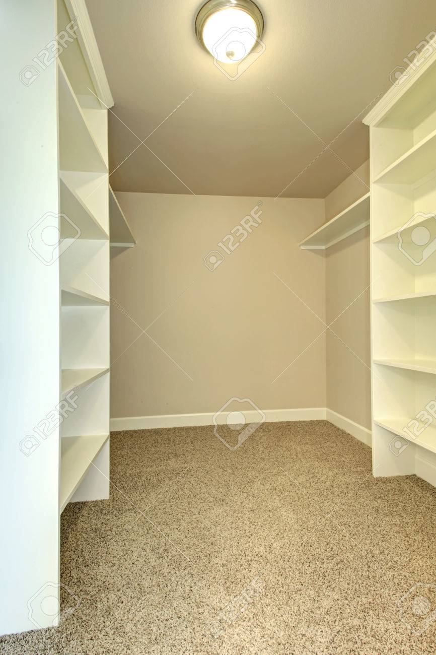 empty walk in closet chandelier bright empty walkin closet with wood shelves beige carpet floor stock photo empty walkin closet with wood shelves beige carpet floor empty walk in closet chandelier bright empty walkin closet with wood shelves beige carpet floor stock photo empty walkin closet with wood shelves beige carpet floor