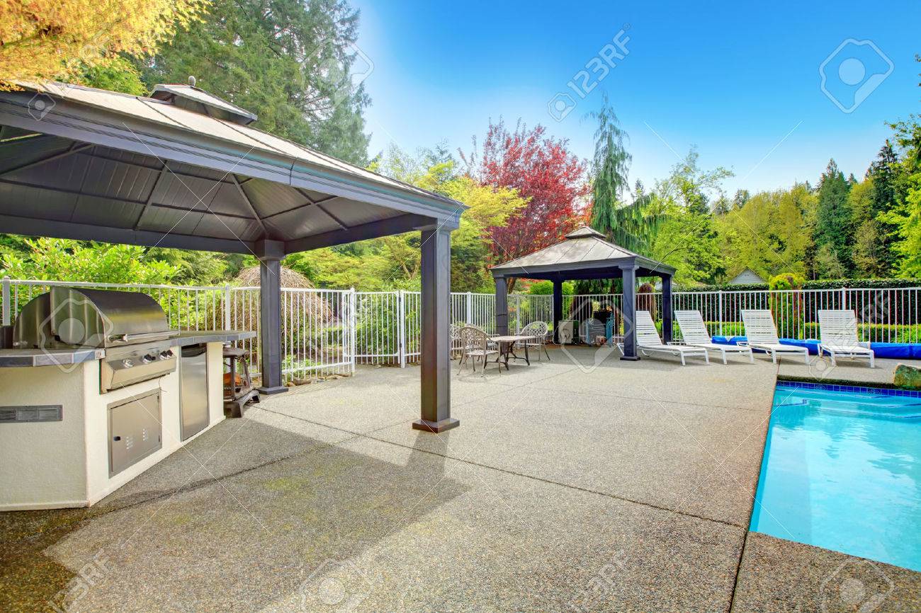 Concrete Floor Patio Area With Barbeque, Table Set, Sun Chairs Concrete Floor Patio Area With Barbeque, Table Set, Sun Chairs