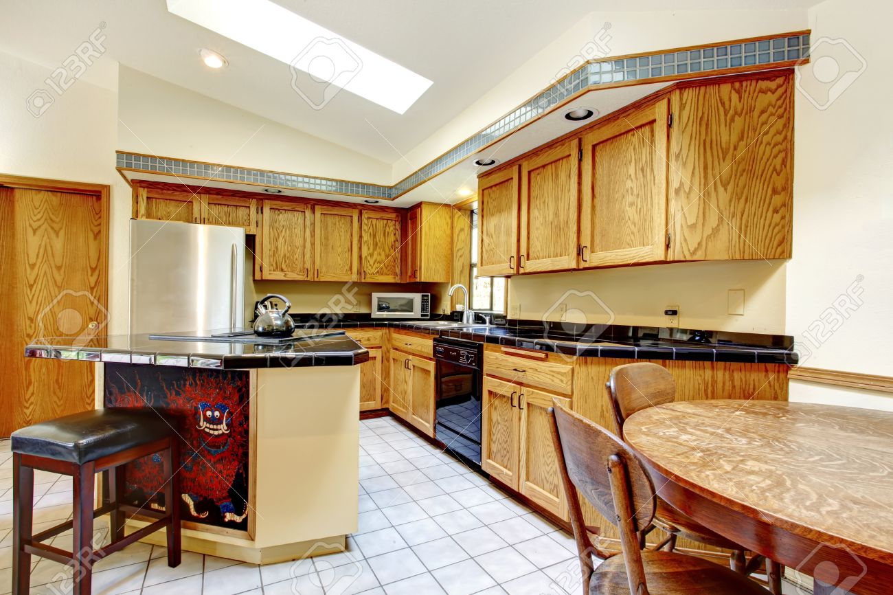 Hight Vaulted Ceiling Kitchen With Light Brown Storage Cabinets