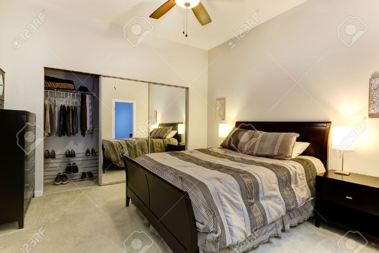 elegant bedroom with dark brown furniture, mirror door closet elegant bedroom with dark brown furniture, mirror door closet