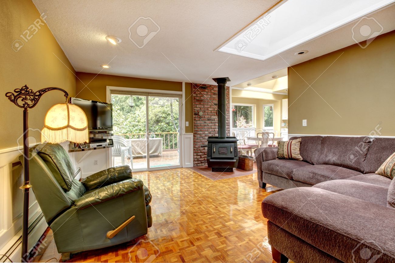 Old Fashioned Living Room With Green Wall And Brick Trim View