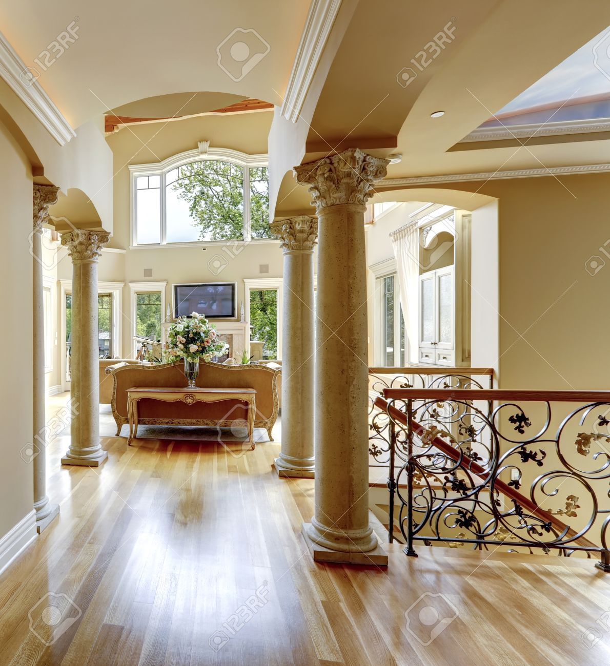 Beautiful Luxury Hallway With Columns. View Of Living Room And Wrought  Railings. Stock Photo, Picture and Royalty Free Image. Image 27538536., image size:1190x1300