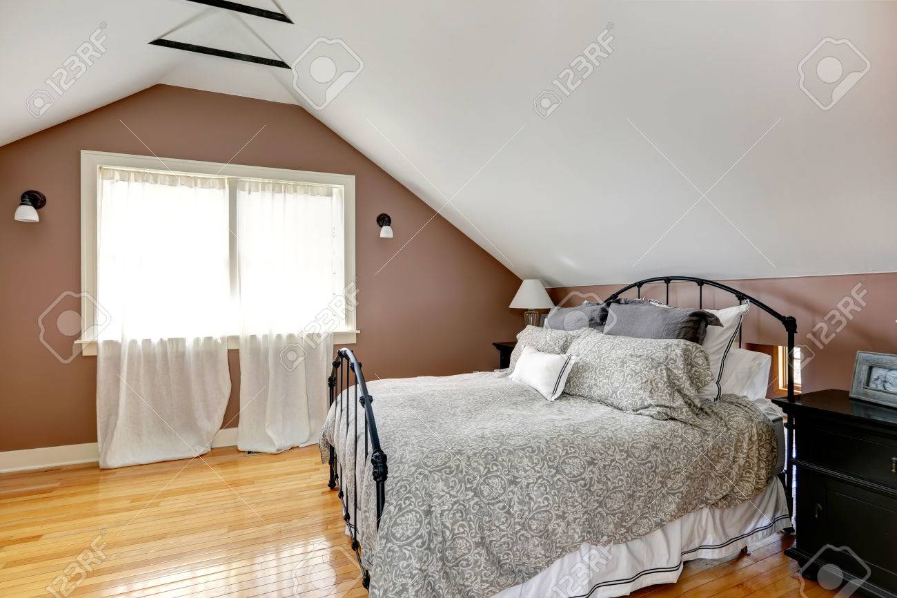velux mocha and white bedroom with curtained window and iron stock