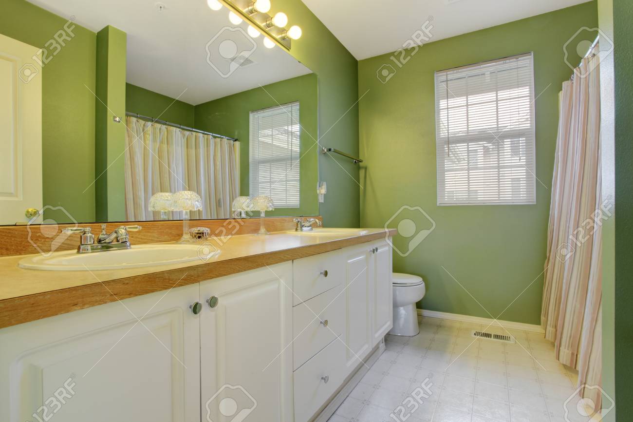 Green Bathroom With White Bathroom Vanity Cabinet And Large Mirror