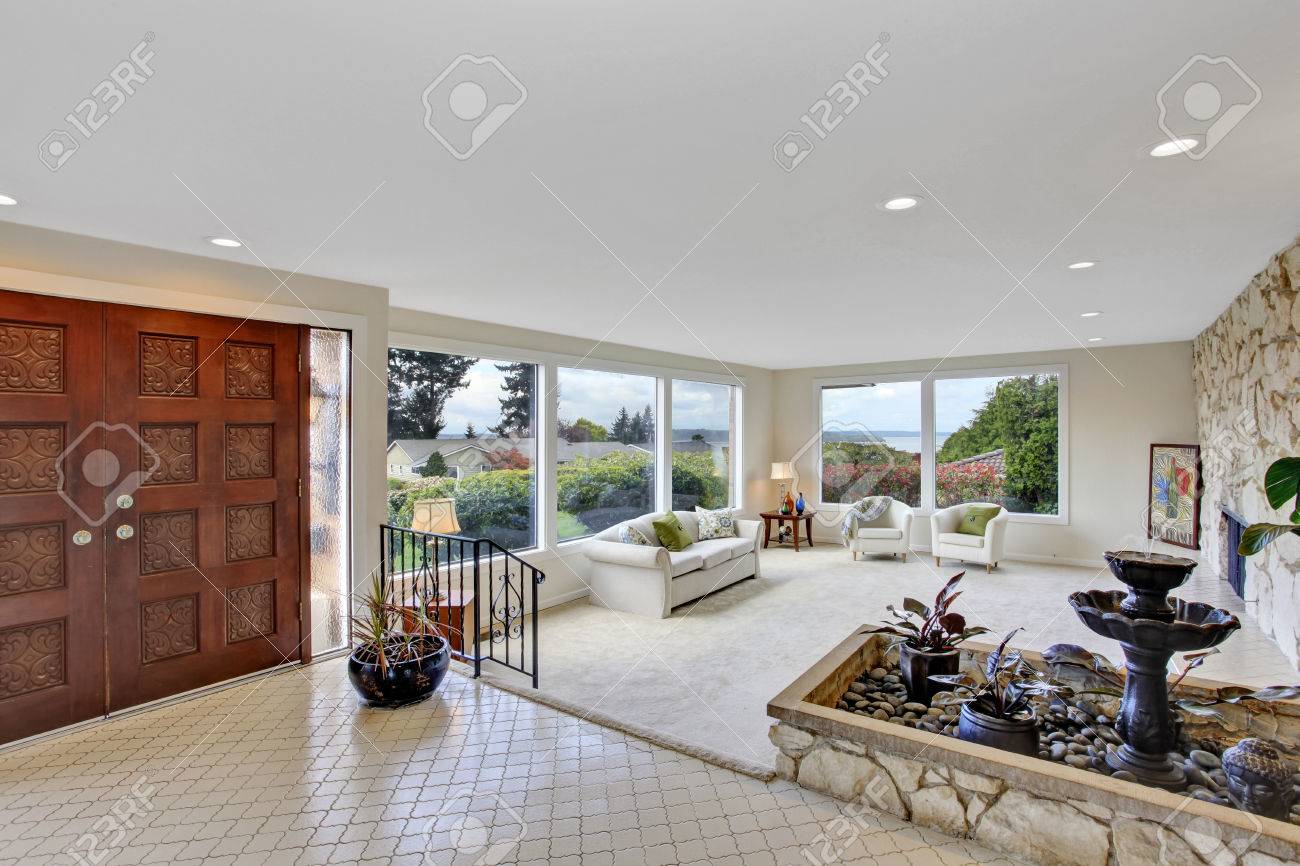 Bright Living Room With Fountain In Luxury House. View Of Entrance ... Bright Living Room With Fountain In Luxury House. View Of Entrance ...