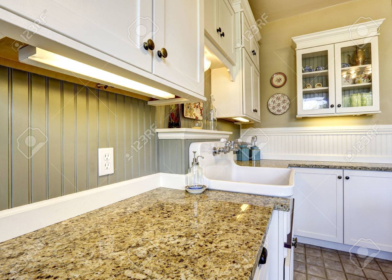 Uncategorized Kitchen Paneling Backsplash white old kitchen cabinets with cganite tops and plank paneled back splash trim stock photo