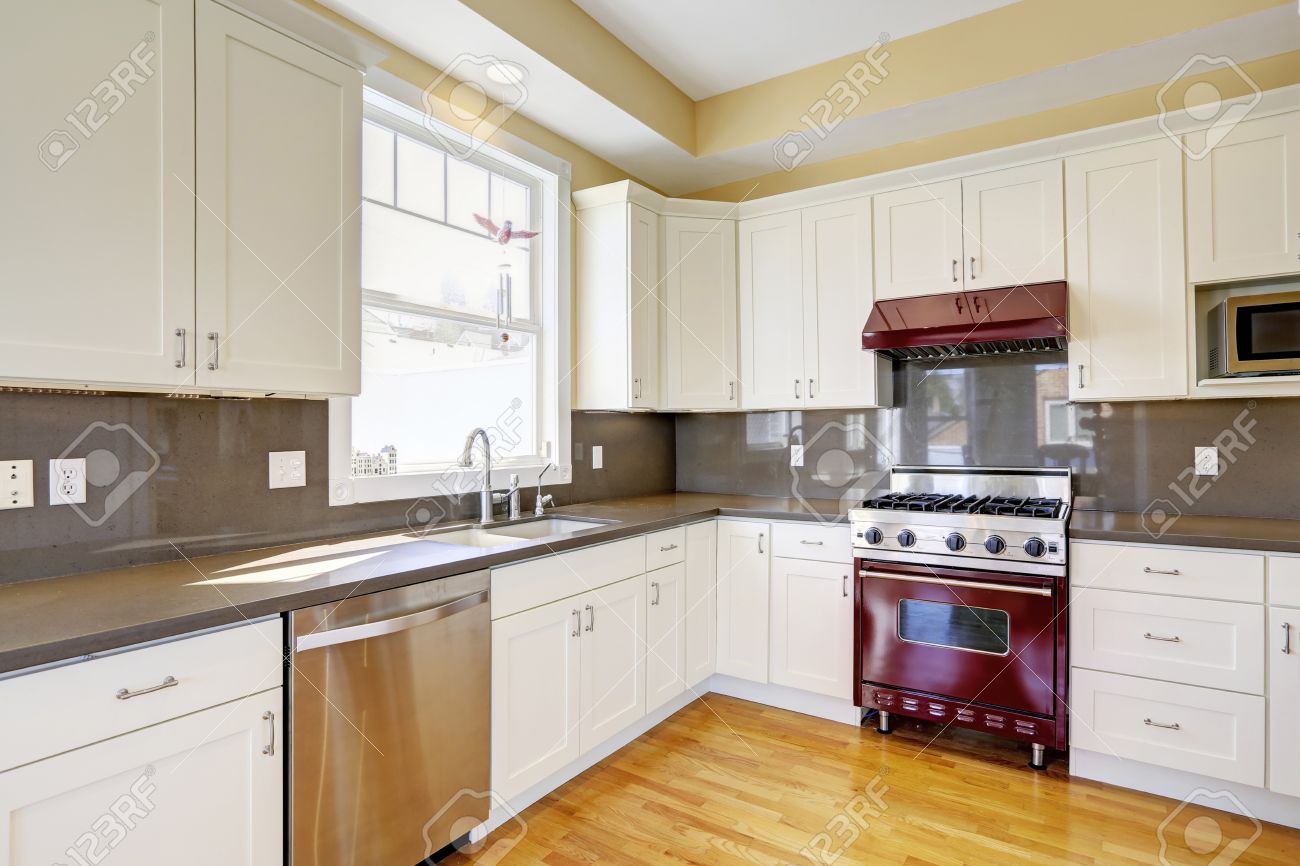 Bright Kitchen Room With Hardwood Floor White Cabinets Burgundy