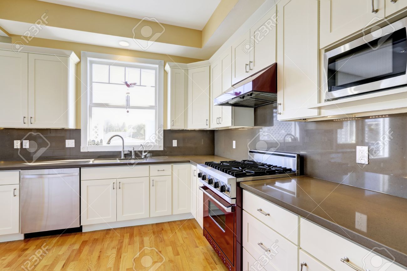 Bright Kitchen Room With Hardwood Floor White Cabinets Burgundy