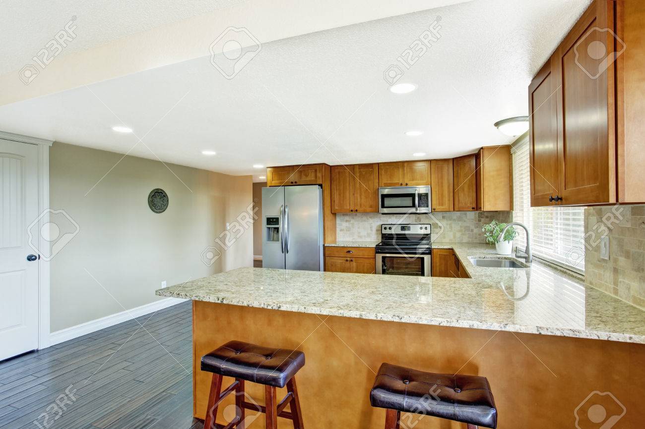 Kitchen Room With Hardwood Floor Brown Cabinets With Granite