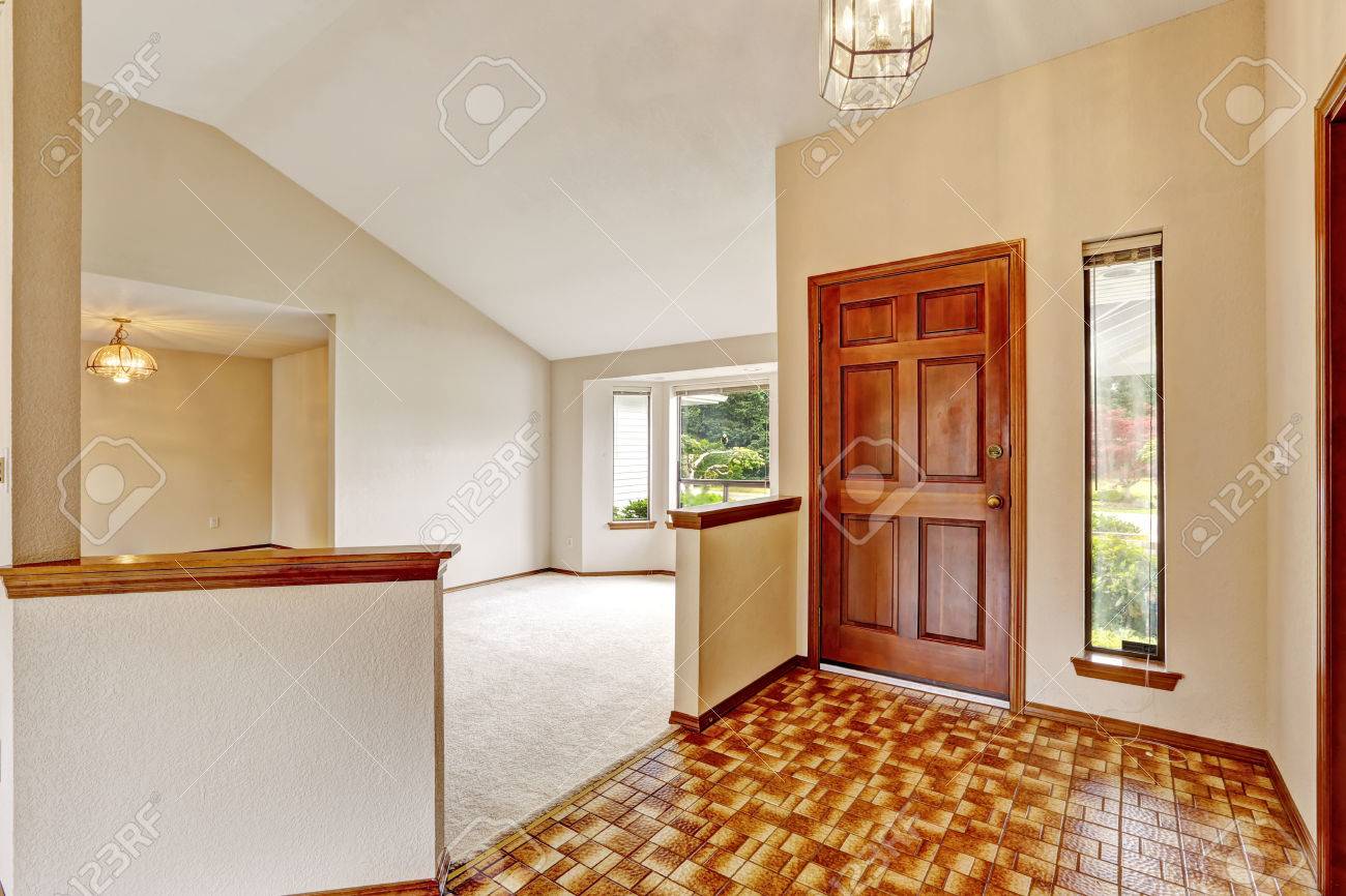 empty house interior. entrance hallway with brown linoleum and empty house interior. entrance hallway with brown linoleum and
