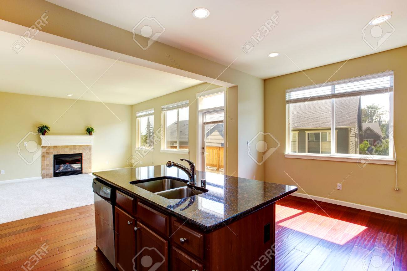 modern kitchen island with granite top and built in sink in empty modern kitchen island with granite top and built in sink in empty