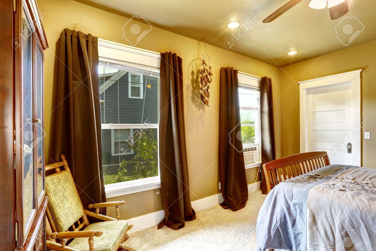 warm tones bedroom with light yellow walls and brown curtains warm tones bedroom with light yellow walls and brown curtains