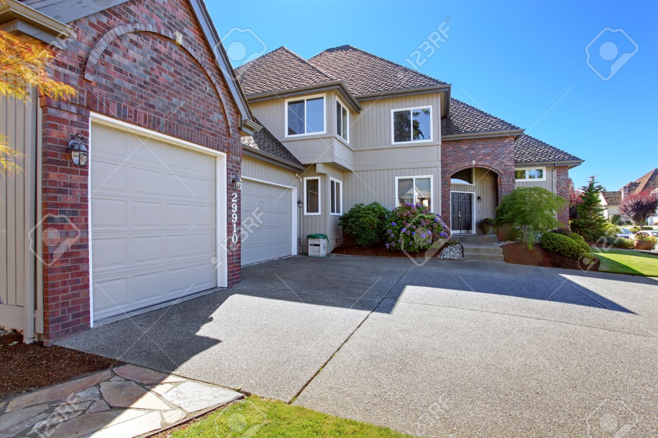 Luxury House With Tile Roof, Brick Trim View Of Garage With Luxury House With Tile Roof, Brick Trim View Of Garage With