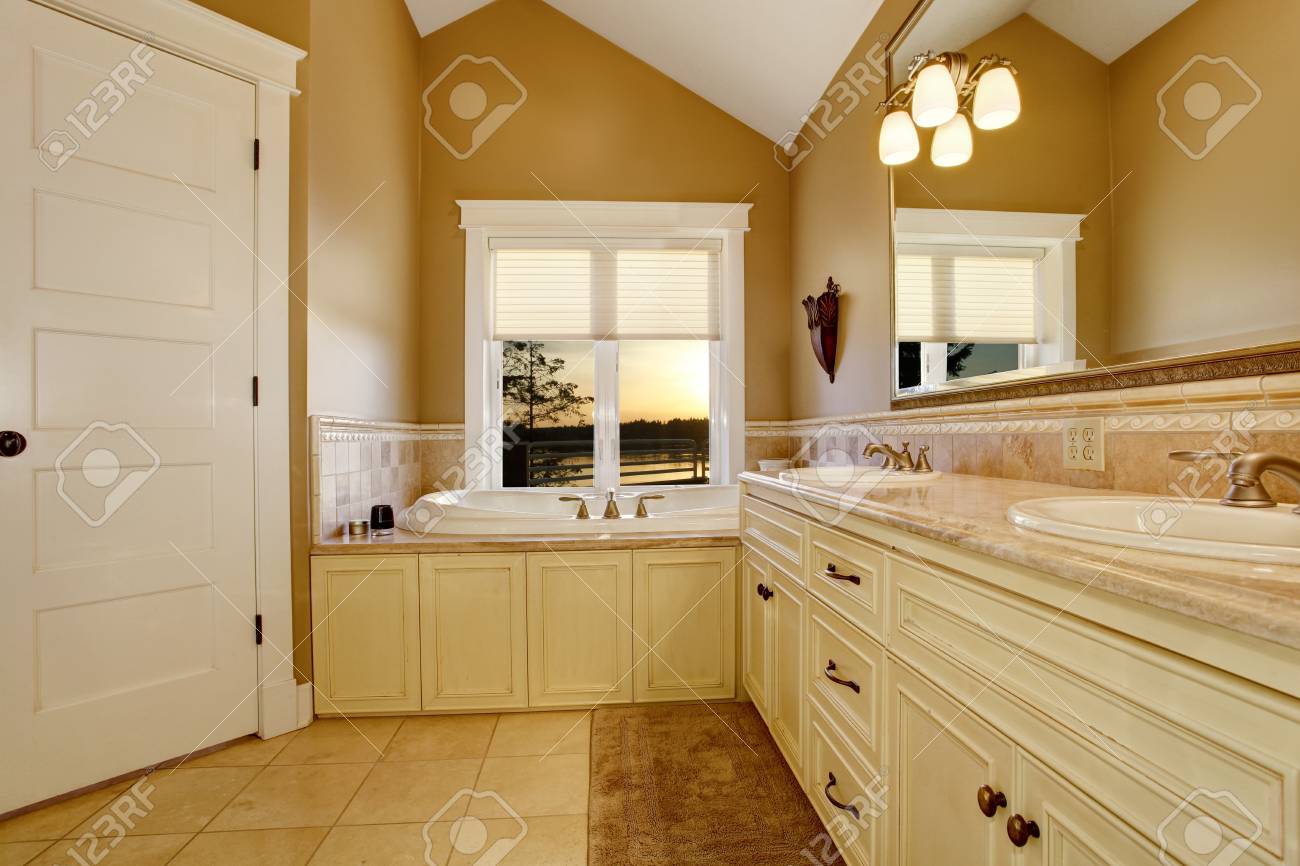 Cozy Bathroom Interior With Old White Cabinets Tile Floor And