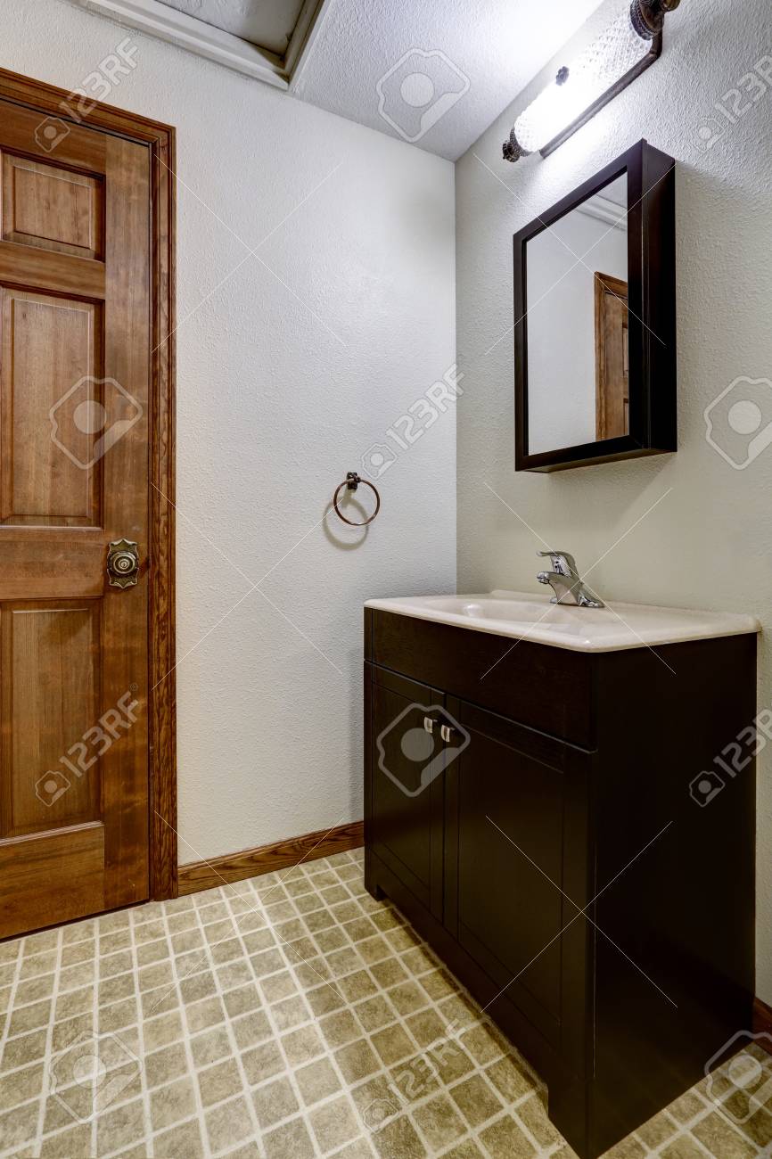 Simple Bathroom Interior With Black Cabinets Tile Floor And