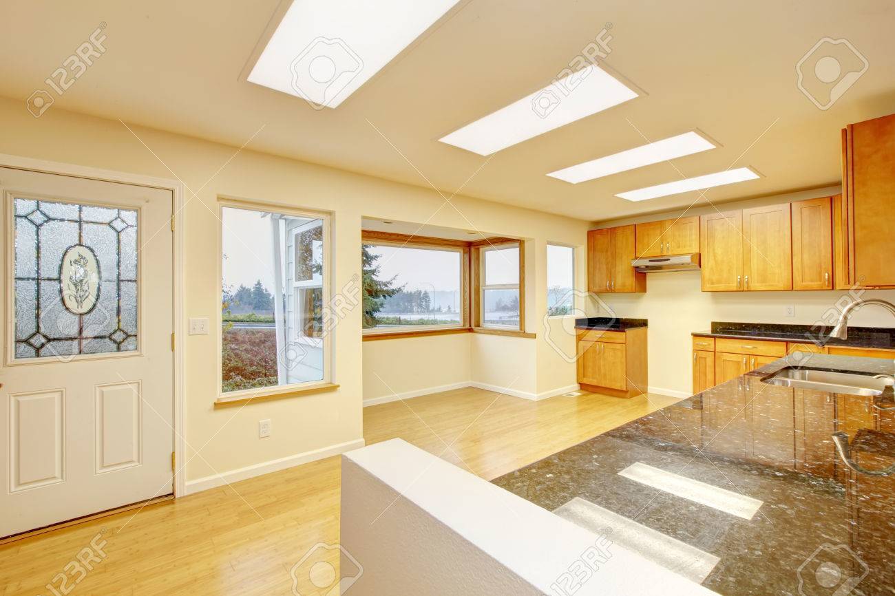 Spacious Kitchen Room With Light Brown Cabinets And Black Granite Counter Tops Hardwood Flooring Spacious Kitchen Room With Light Brown Cabinets And Black Granite Counter Tops Hardwood Flooring
