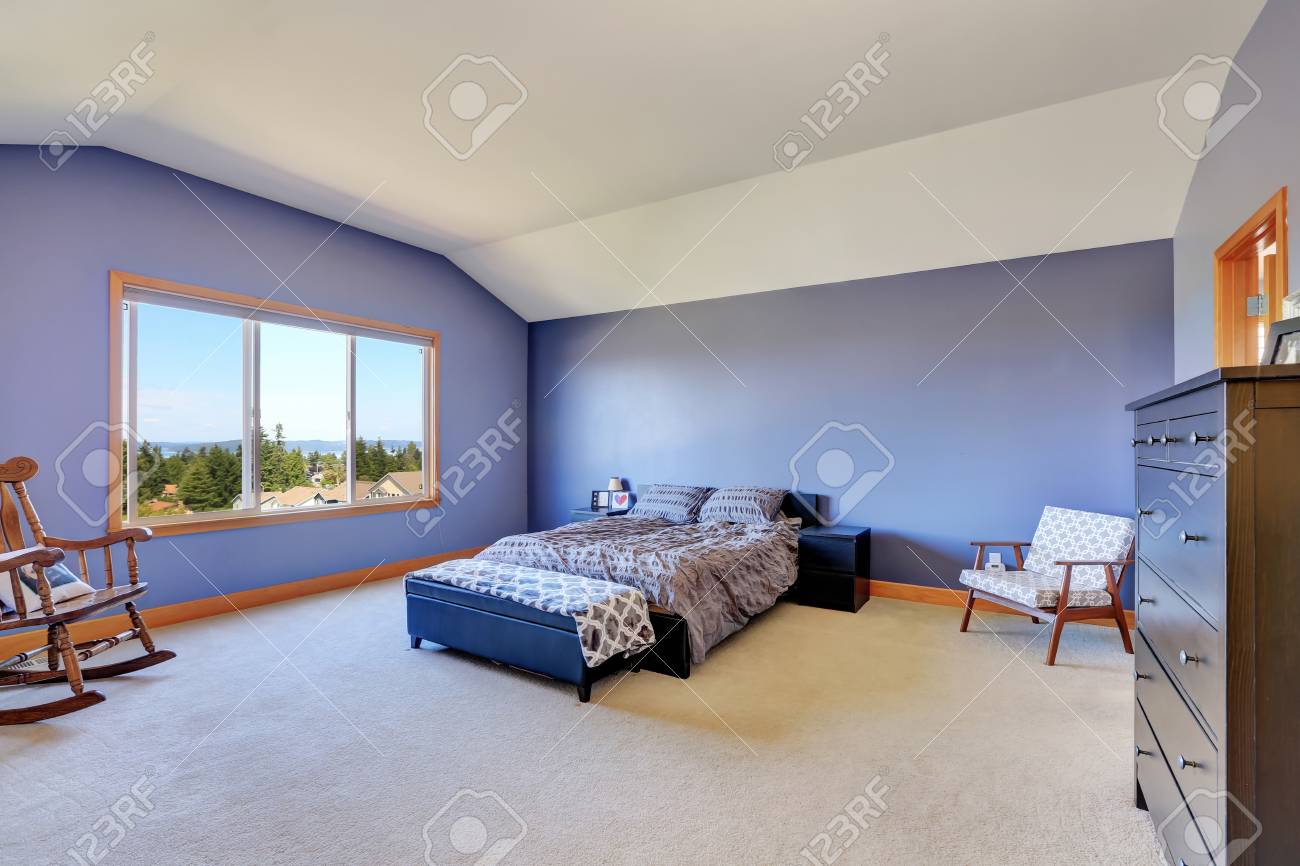 Spacious Blue Bedroom With Vaulted Ceiling Furnished With Rocking