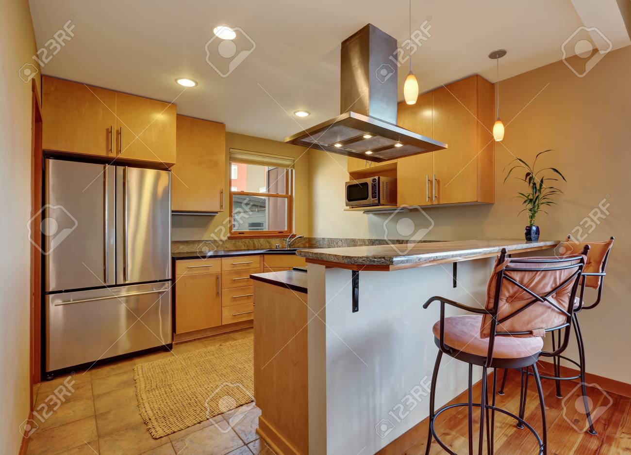 Small Kitchen Room Interior With Light Brown Cabinets And Tile