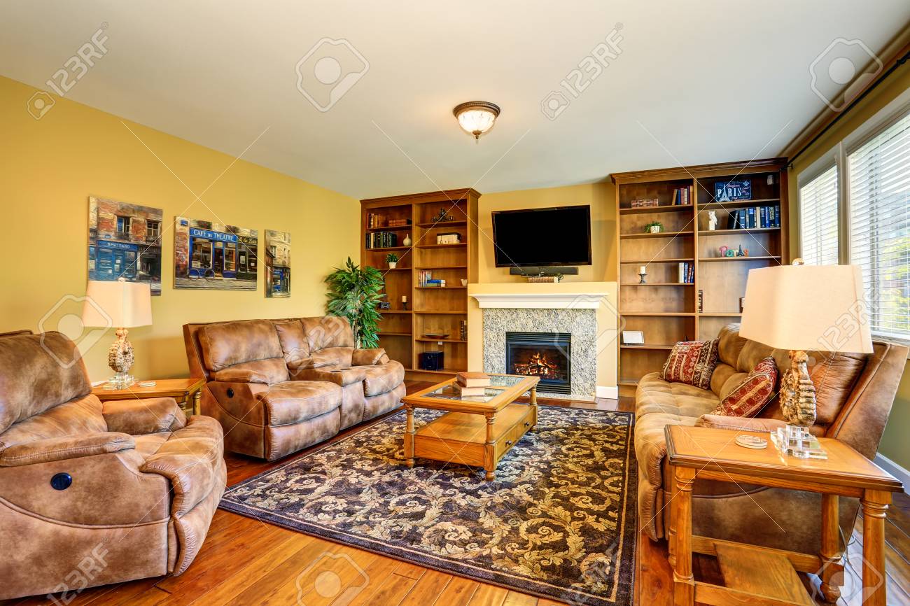 Typical American Living Room Design With Fireplace And Sofa Set