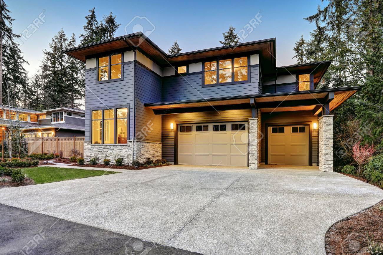 Luxurious new construction home in Bellevue, WA. Modern style home boasts two car garage framed by blue siding and natural stone wall trim. Northwest, USA - 70311787 Luxurious new construction home in Bellevue, WA. Modern style home boasts two car garage framed by blue siding and natural stone wall trim. Northwest, USA - 70311787