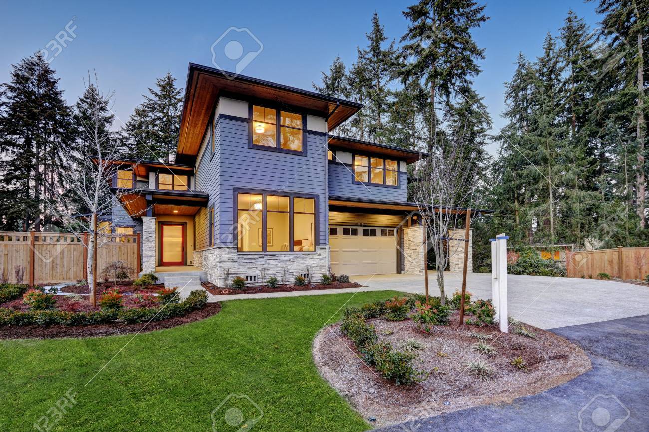 Luxurious new construction home in Bellevue, WA. Modern style home boasts two car garage framed by blue siding and natural stone wall trim. Northwest, USA - 70296417 Luxurious new construction home in Bellevue, WA. Modern style home boasts two car garage framed by blue siding and natural stone wall trim. Northwest, USA - 70296417