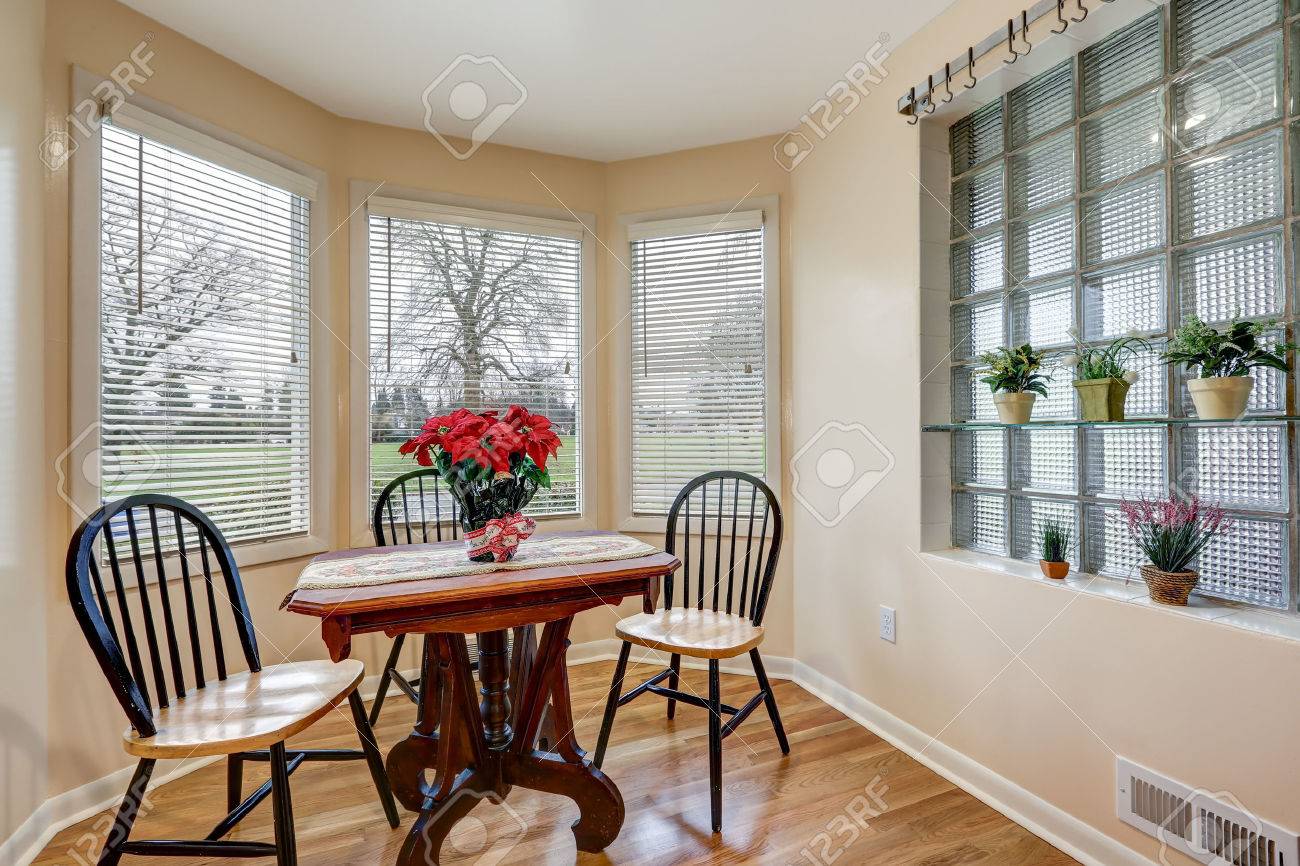 Light Filled Breakfast Nook With Soft Peach Walls Furnished With