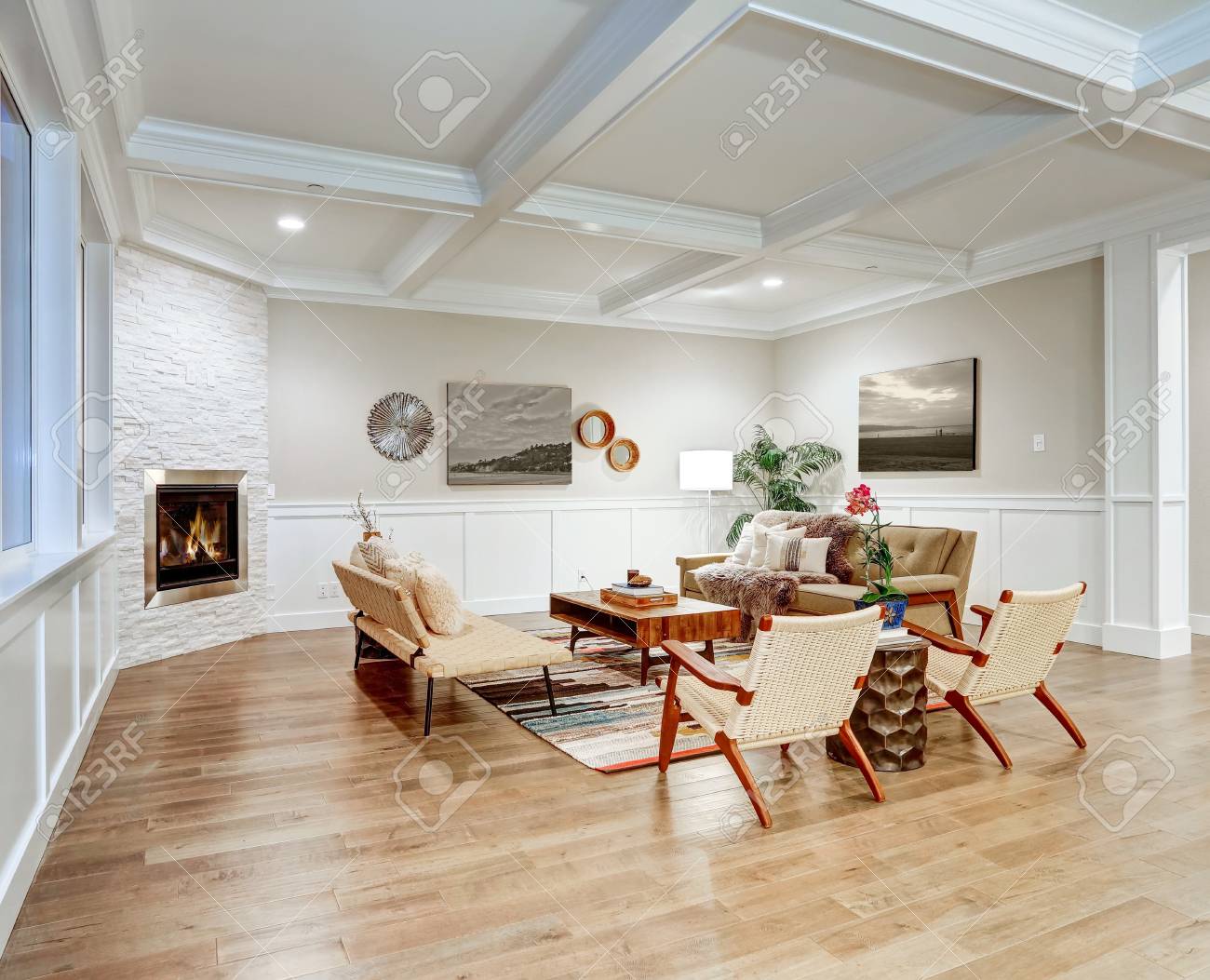 Lovely Craftsman Style Living Room With Coffered Cealing Over Light Beige  Walls With Board And Batten Wood Paneling, Stone Corner Fireplace And Cozy  Sofas Atop Colorful Rug. Northwest, USA Stock Photo, Picture, image size:1300x1053