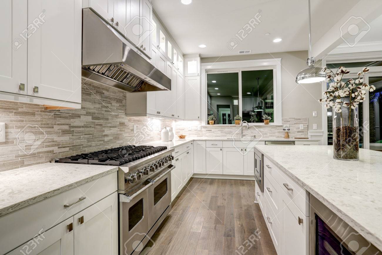 Gourmet Kitchen Features White Shaker Cabinets With Marble