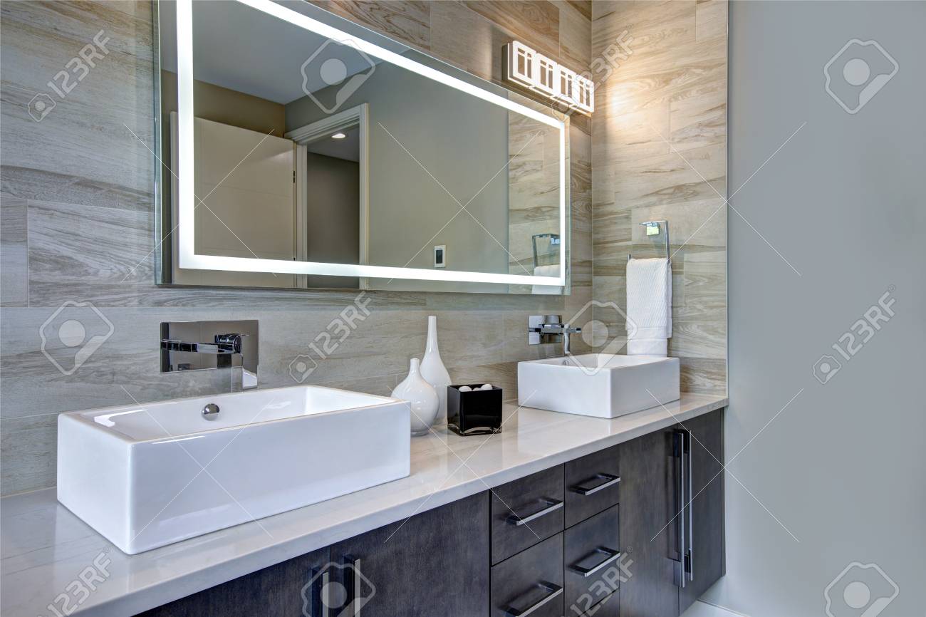 Contemporary Master Bathroom Features A Dark Vanity Cabinet Fitted