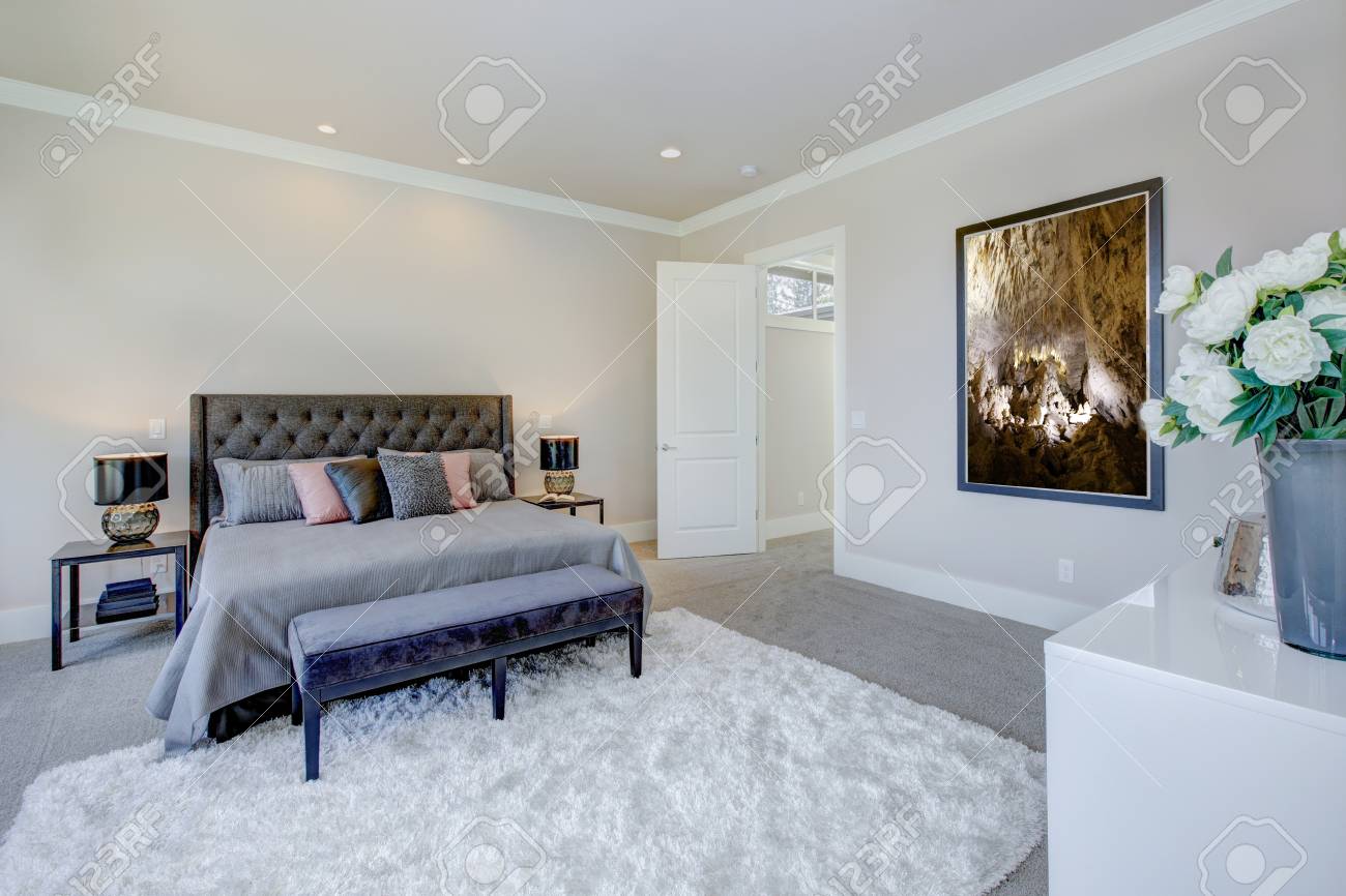 Light Filled Bedroom Showcases A King Size Bed With Tufted Headboard