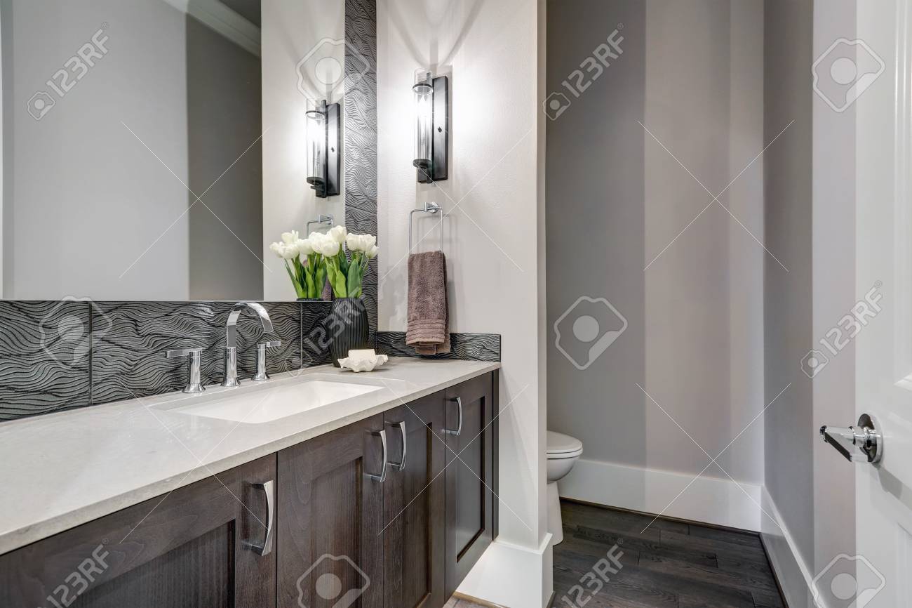 White And Brown Bathroom Boasts A Nook Filled With A Taupe Vanity - White And Brown Bathroom Boasts A Nook Filled With A Taupe Vanity