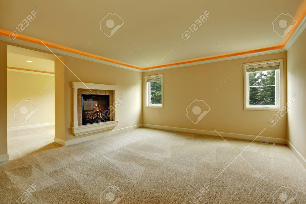 Empty Master Bedroom With Two Sided Fireplace And Beige Spacious