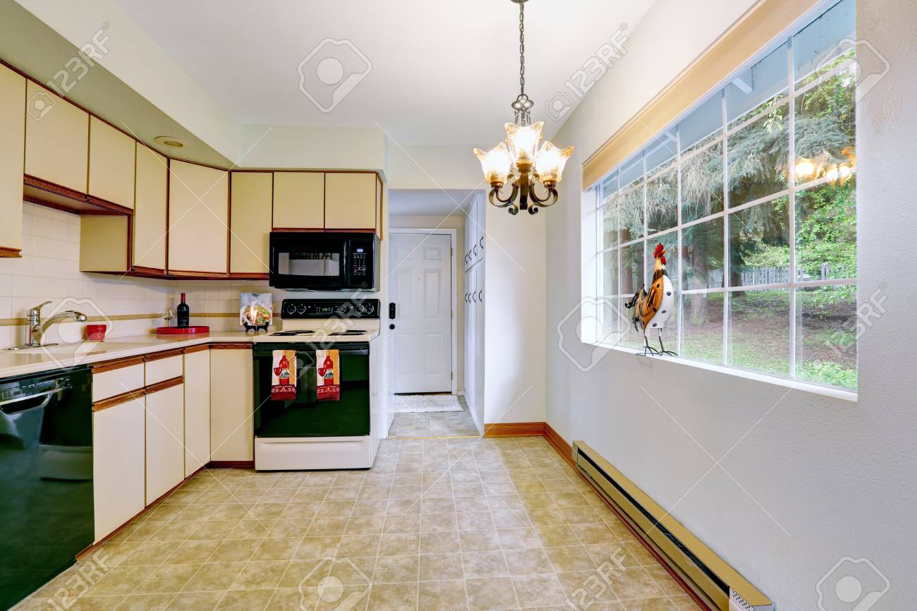 Remodeled Kitchen Room With Cream Cabinets Black Appliances