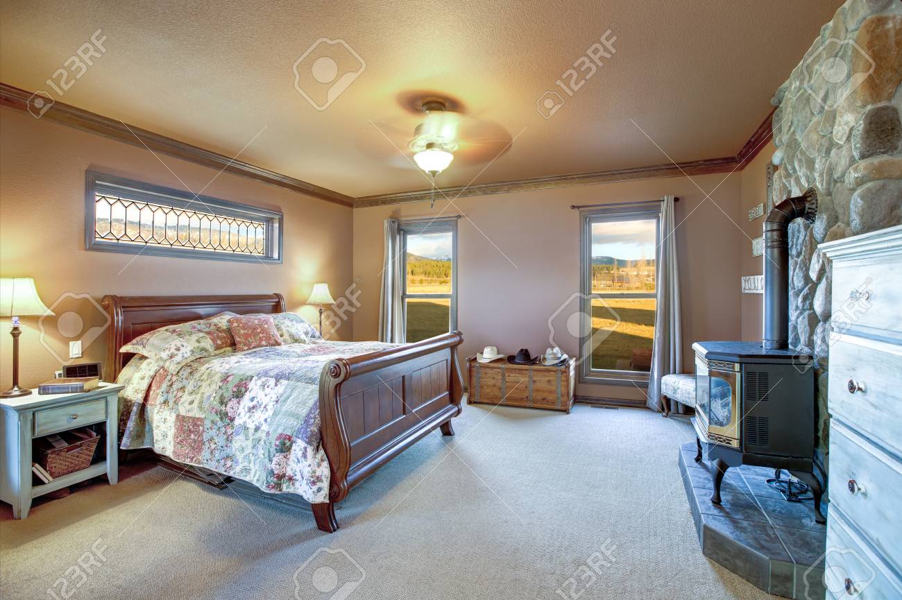 Master Bedroom Interior With Wooden Sleigh Bed, Old Wood Burning - Master Bedroom Interior With Wooden Sleigh Bed, Old Wood Burning
