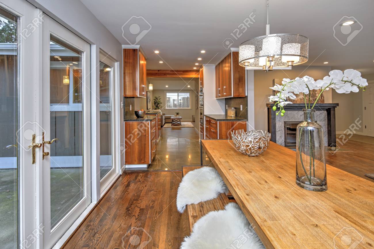 Spacious Dining Room With Wooden Dining Table And French Doors Stock Photo