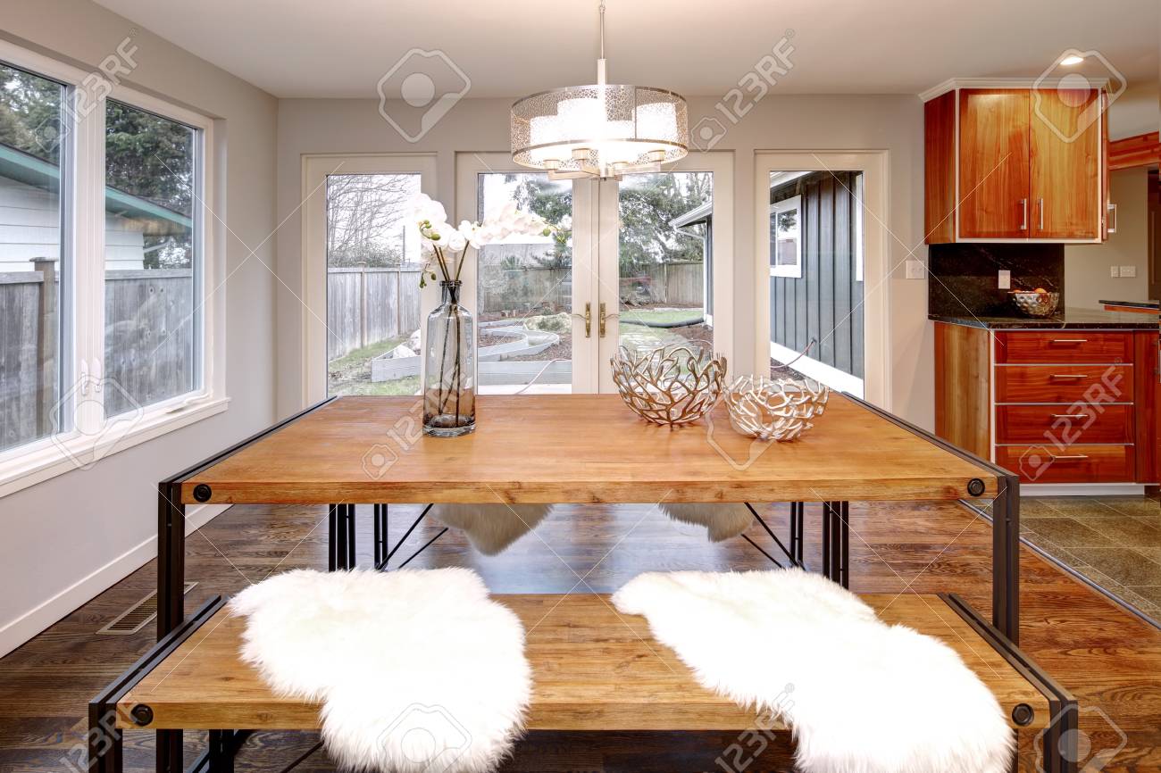 Spacious Dining Room With Wooden Dining Table And French Doors Stock Photo