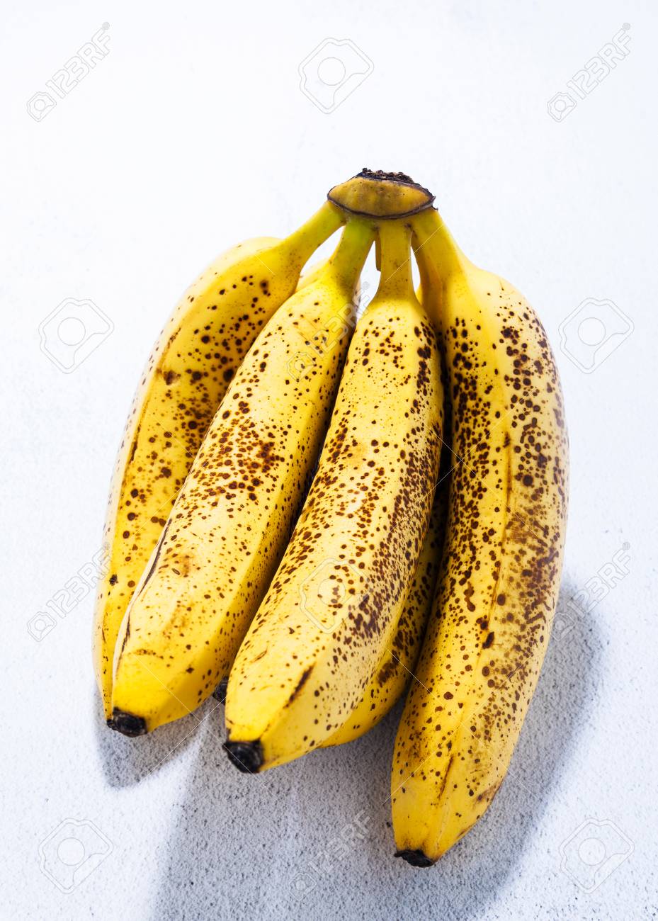 Banana On Table Branch Of Overripe Bananas With Black Dots On The Table. Natural Sweetener. Concept Of Banana On Table Branch Of Overripe Bananas With Black Dots On The Table. Natural Sweetener. Concept Of
