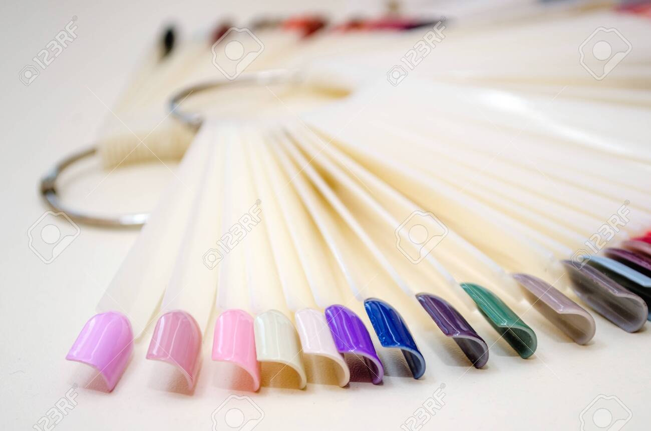 Palette of nail designs of different colors with gel polish on a white tips and background. Collection of plastic testers for nail polish - 140075197 Palette of nail designs of different colors with gel polish on a white tips and background. Collection of plastic testers for nail polish - 140075197