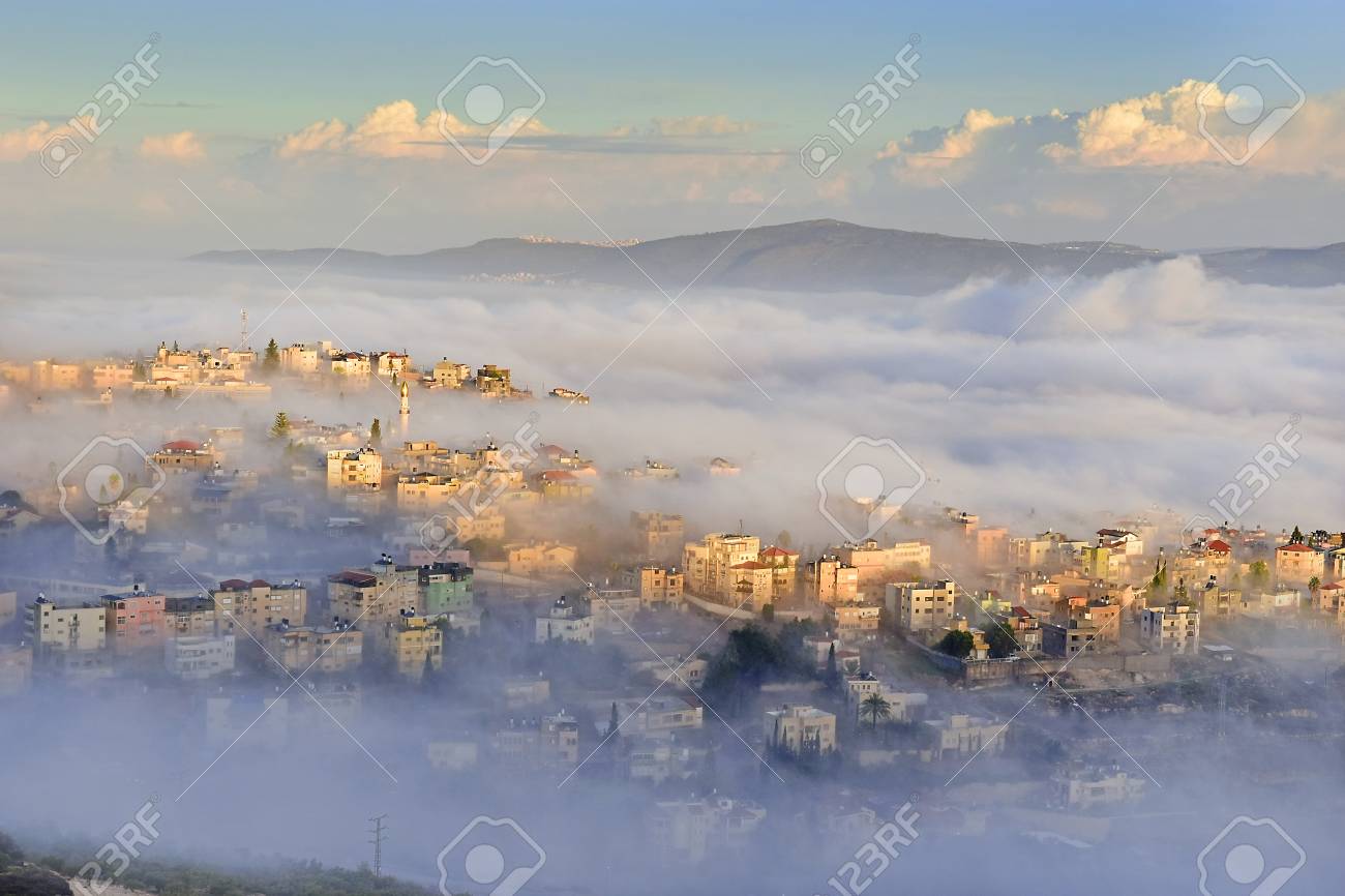 Stock Photo View Of The Shrouded In The Morning Fog Biblical Village Cana Of Galilee Kafr Kanna Neighborhood Nazareth In Israel Place Where Jesus Stock Photo View Of The Shrouded In The Morning Fog Biblical Village Cana Of Galilee Kafr Kanna Neighborhood Nazareth In Israel Place Where Jesus