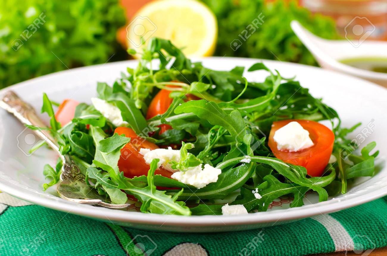 Green salad with arugula, tomato and feta cheese. Italian cuisine - 43216526 Green salad with arugula, tomato and feta cheese. Italian cuisine - 43216526
