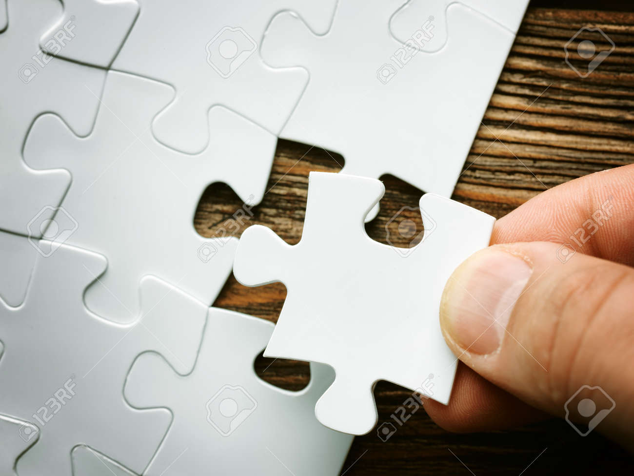hand with missing jigsaw puzzle piece business concept image