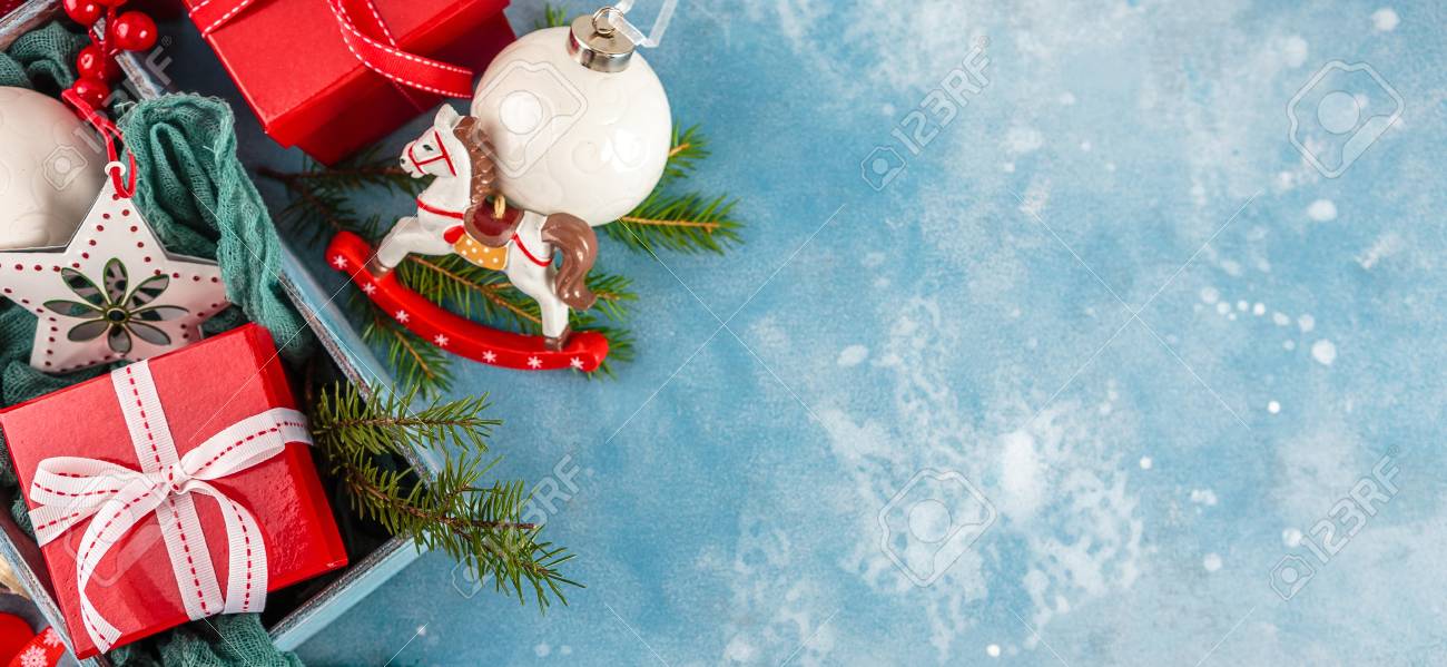 Christmas Toys In Wooden Box And Red Gift Boxes On Blue Background. Top View Stock Photo, Picture And Royalty Free Image. Image 109133296. Christmas Toys In Wooden Box And Red Gift Boxes On Blue Background. Top View Stock Photo, Picture And Royalty Free Image. Image 109133296.