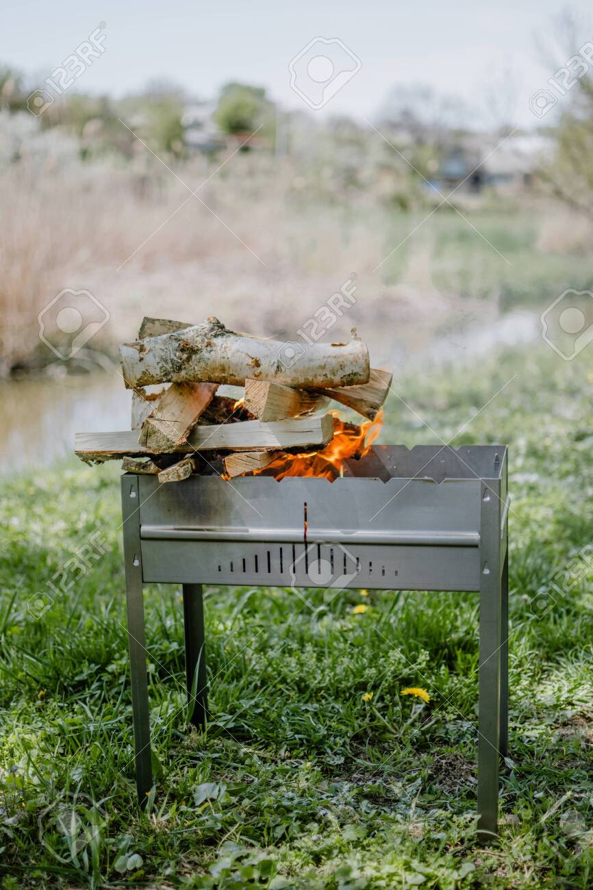 Metal Portable Barbecue With Burning Firewood And Red Flames Bonfire, picnic, barbecue, barbecue firewood, cook, barbecue