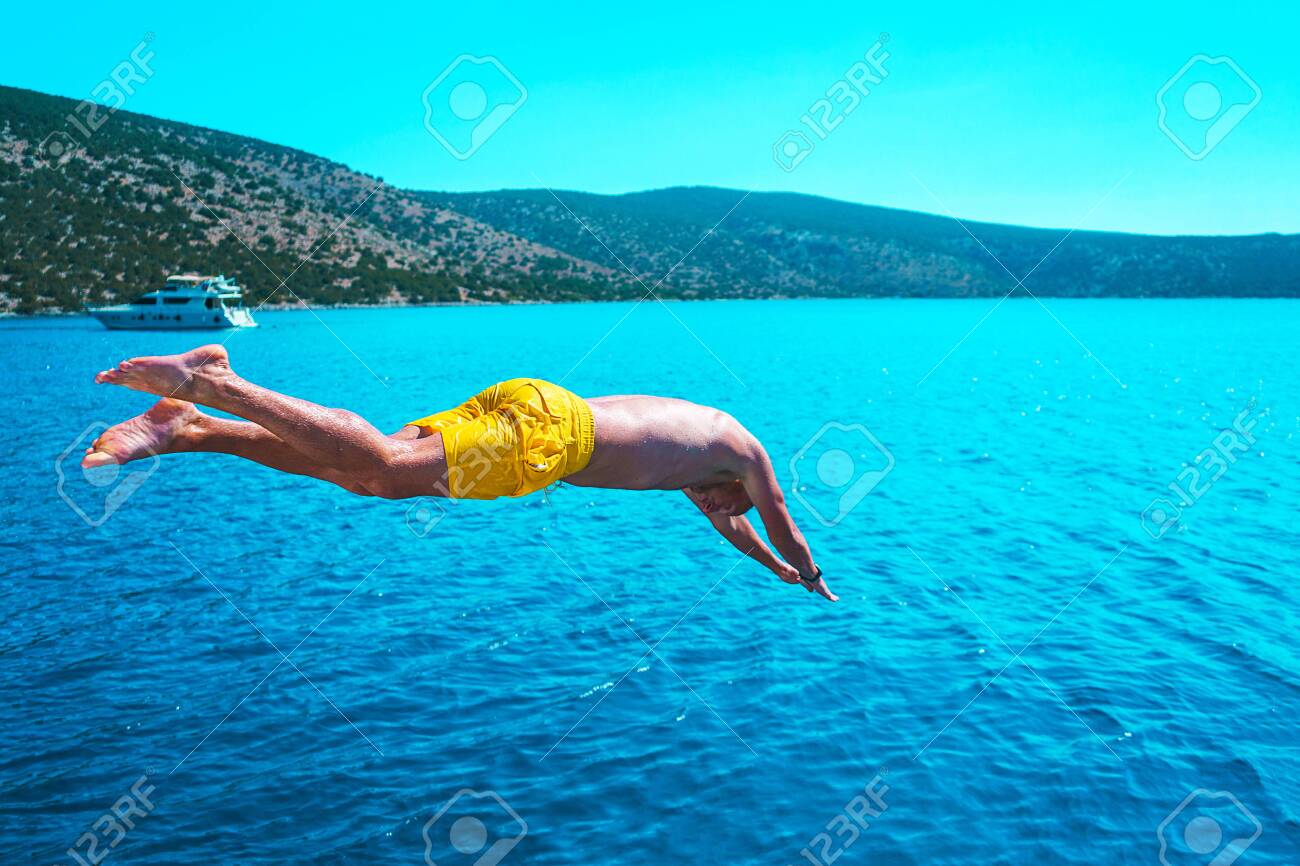 Young Man Diving Into The Turquoise Water Of The Sea From Yacht Having A Great Summer Vacation Stock Photo Picture And Royalty Free Image Image 130644355