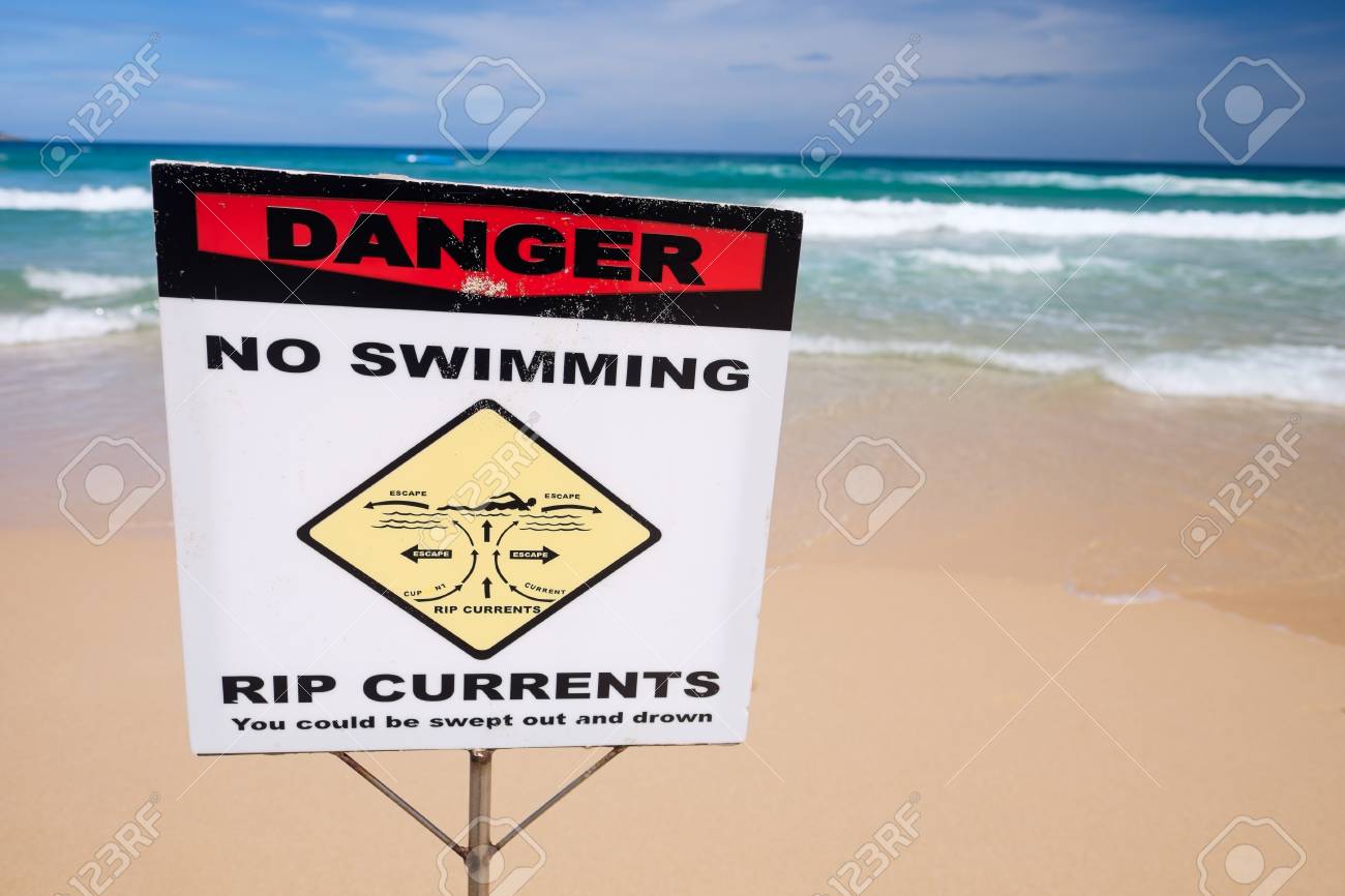 No Swimming Warning Sign On The Beach. Stock Photo, Picture and Royalty  Free Image. Image 74794669., image size:1300x866