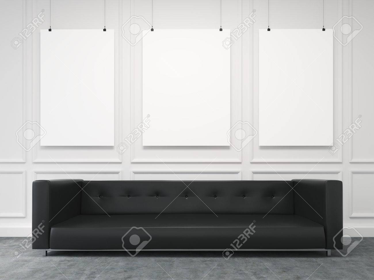 Un Largo Sofa Negro De Pie En La Pared Blanca Tres Cuadros En